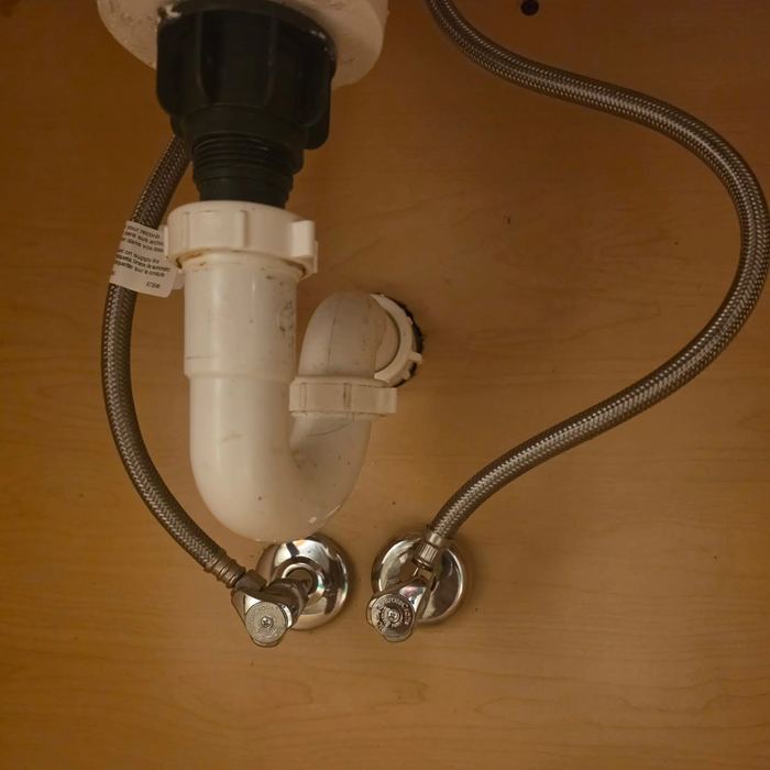 New P-trap and supply lines under a sink