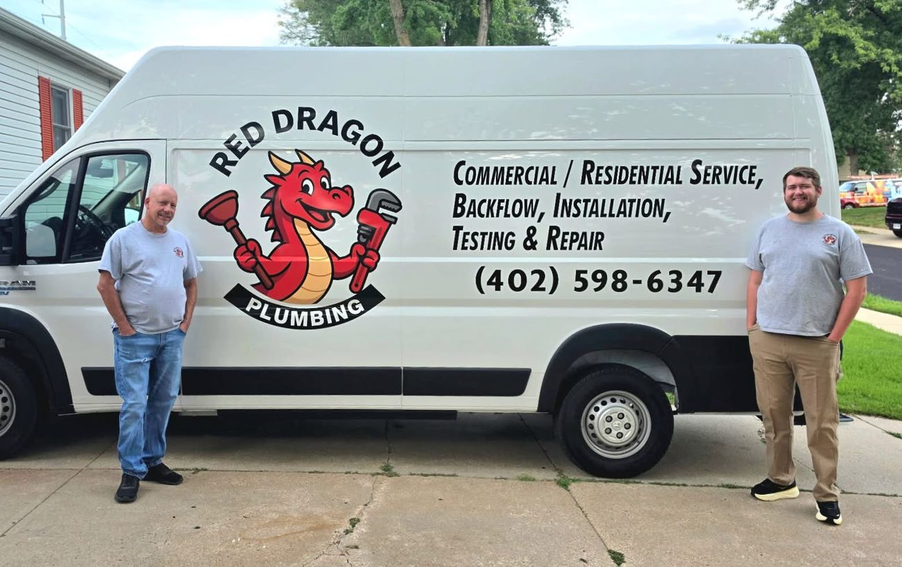 Monte and his son Nathan in front of the Red Dragon Plumbing van